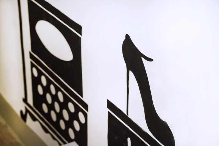 Elegant interior featuring a simple design with a typewriter and a shoe.