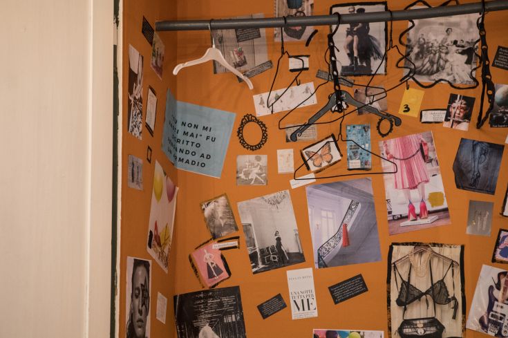 A wall adorned with photographs and notes, enhanced by a quote on an orange background.