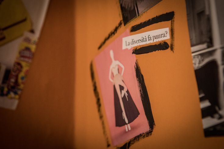 A manifesto featuring a stylized figure on an orange background, encouraging reflection on diversity.