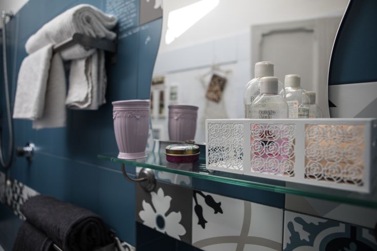 Well-furnished bathroom with towels, personal care products, and a tranquil atmosphere.