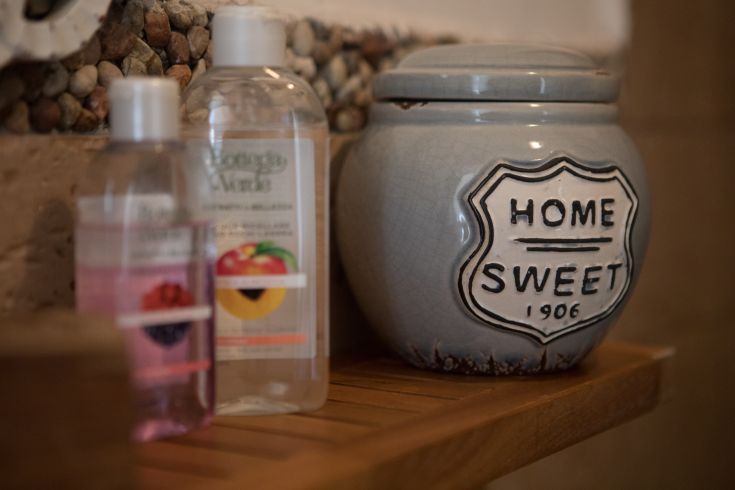 A bathroom corner featuring personal care products and a decorative jar.