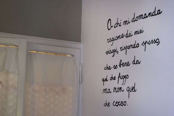 A wall writing reflecting on inner exploration and the value of travel in everyday life.