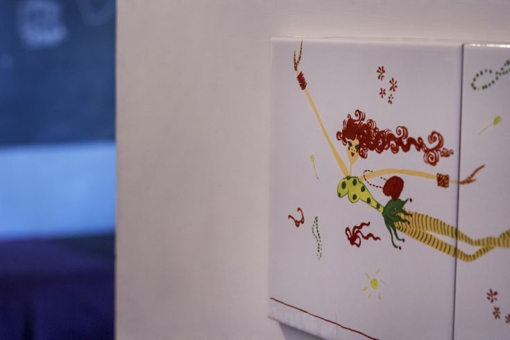 Decorative illustration on an electrical outlet with stylized designs and vibrant colors.