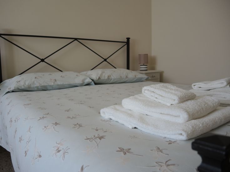 Simple room with tidy beds and fresh towels, perfect for a relaxing moment.