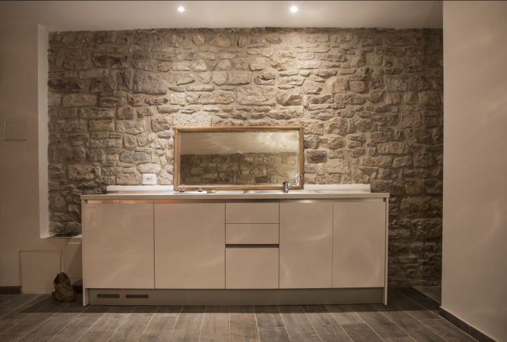 Stone kitchen with masonry, featuring simple furnishings and a cozy atmosphere.