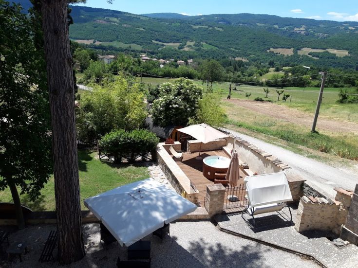A countryside agriturismo surrounded by nature, featuring relaxation areas and a hot tub.