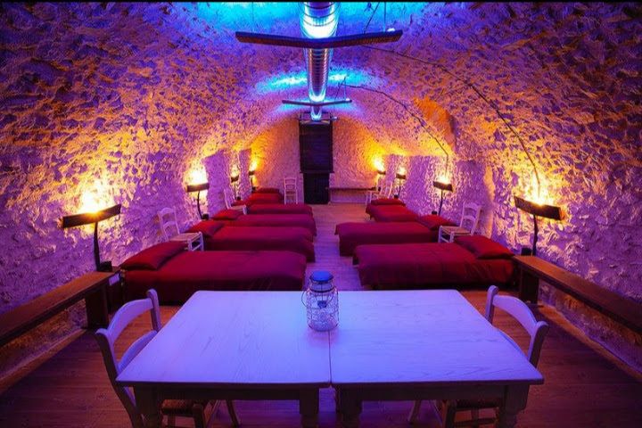 A tranquil setting with neatly arranged beds and warm lighting, perfect for relaxation.