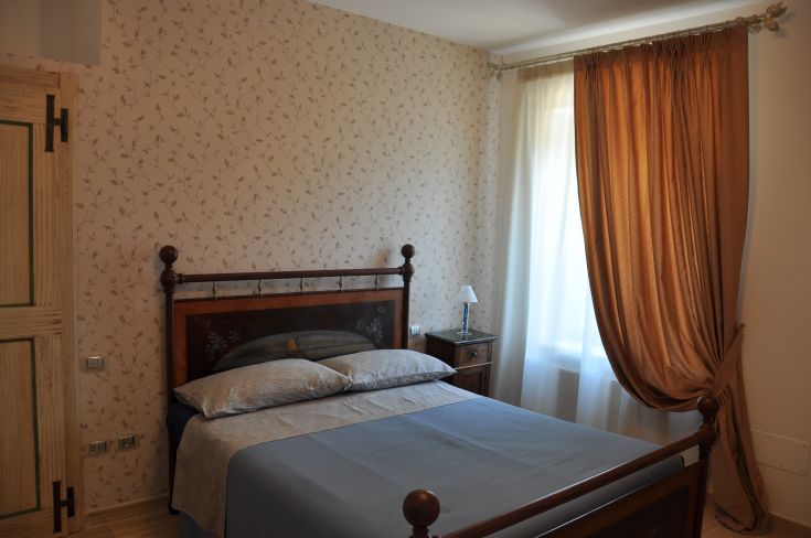 Recently renovated room with simple furnishings and windows overlooking the natural landscape.