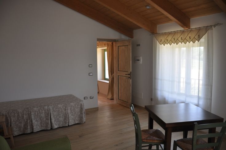 Bright interior of a restored building, featuring practical furnishings and a cozy atmosphere.