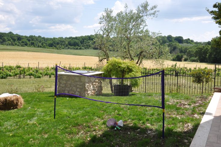 A sports field located in the Umbrian countryside, surrounded by trees and vineyards that shape the landscape.