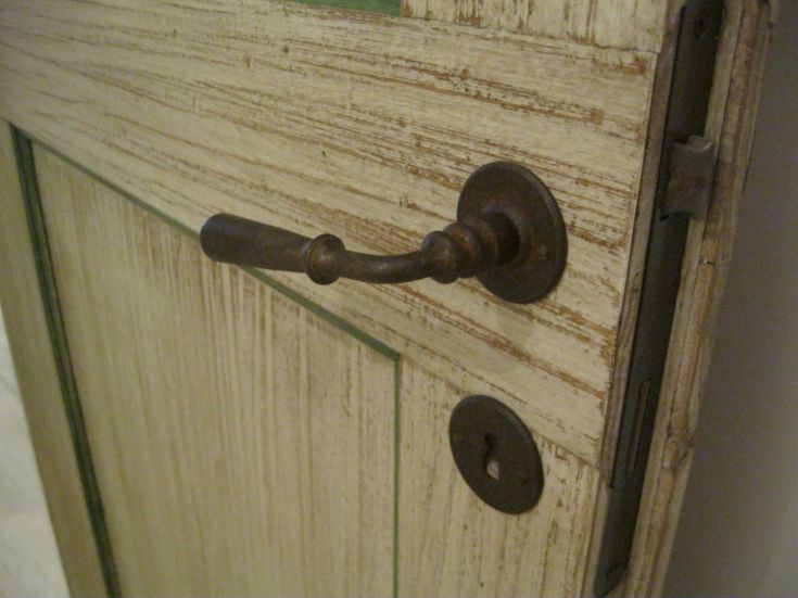 Close-up of a wooden door handle and lock with a simple, natural finish.