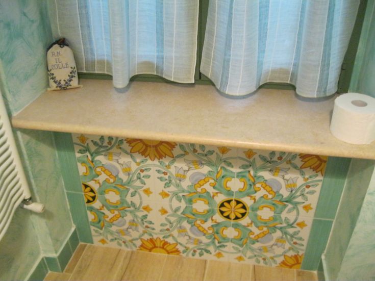 A warm indoor space with vibrant tiles and a window illuminating the room, perfect for a home.