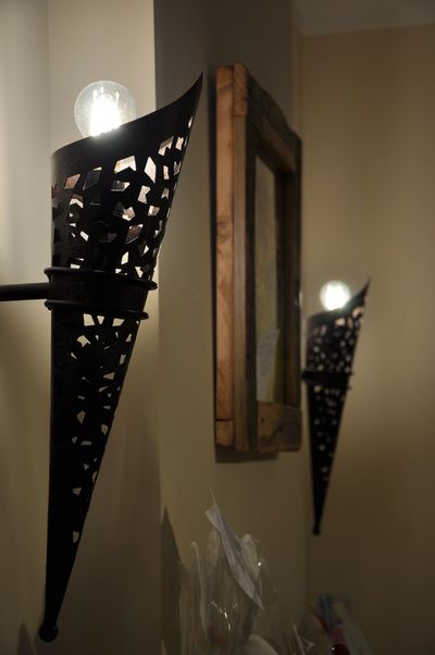 Cozy atmosphere with soft lighting from decorative lanterns and a mirror reflecting light.