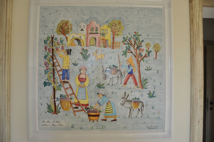 Murals depicting scenes of peasant life, featuring figures at work in a rural setting.