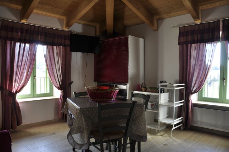 Cozy living room in a renovated building, surrounded by a lush Umbrian landscape.