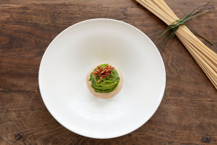 A simple dish with fresh vegetables and a crunchy garnish, served neatly.