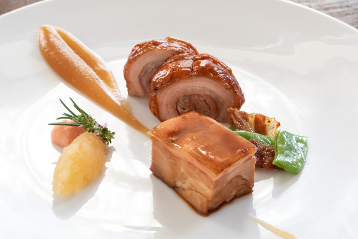 A well-prepared dish featuring meat and side dishes, presented simply.