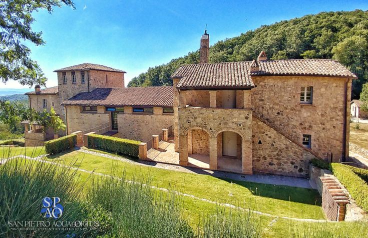 A medieval village featuring stone buildings, set in a peaceful natural environment, perfect for visitors seeking relaxation.