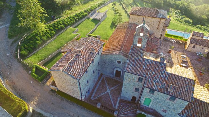 A medieval village surrounded by greenery, featuring stone streets and ancient buildings, perfect for a relaxing stroll.
