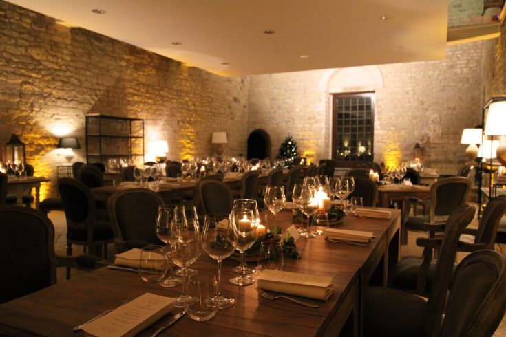 A modern restaurant featuring contemporary furnishings and soft lighting, with tables ready for guests.