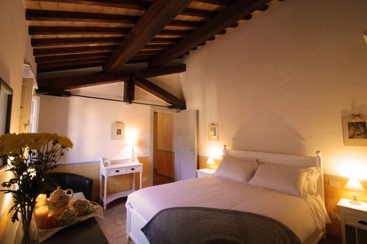 Cozy room with exposed wooden beams, perfect for a peaceful stay.