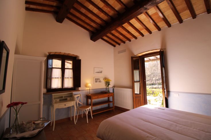 Cozy room with wooden ceilings, garden view, and modern comforts.