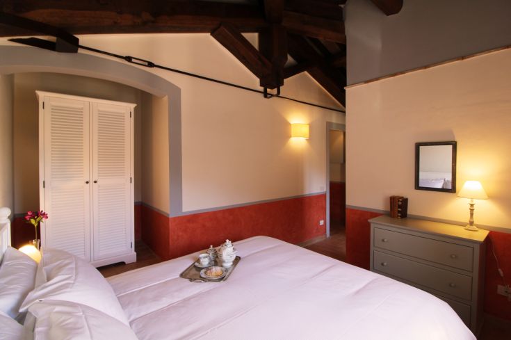 A double bedroom with a modern bed, stylish furniture, and warm lighting for a cozy atmosphere.