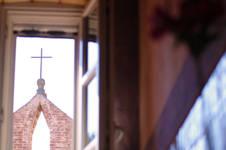 Landscape of rooftops and a bell tower in a charming village, evoking a peaceful atmosphere.
