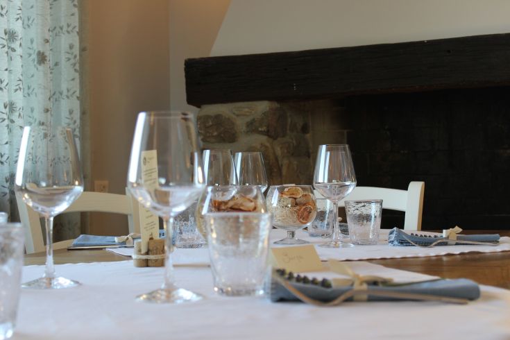 A well-set table with glasses, ready for a lunch gathering.