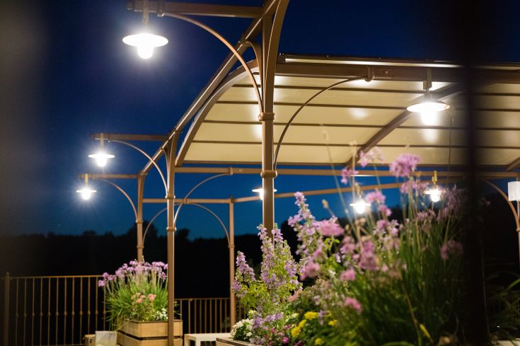 A building surrounded by a garden, located in a quiet rural area.