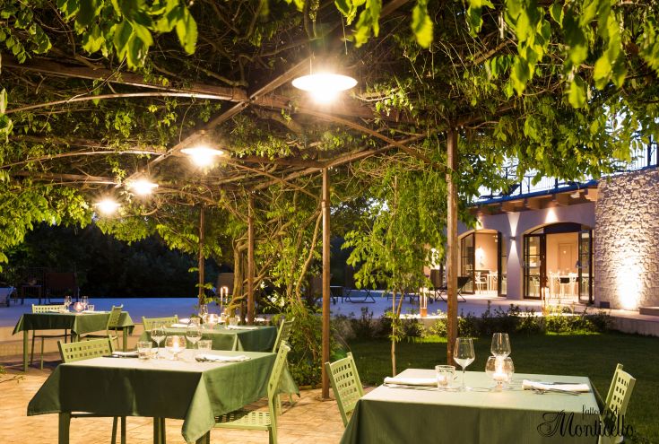 An outdoor restaurant surrounded by lush greenery, ideal for dining al fresco in a peaceful setting.