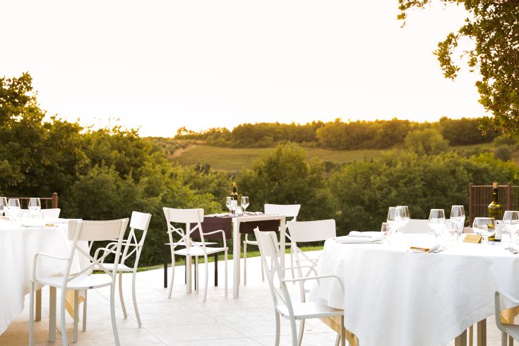 A peaceful area for an outdoor meal, surrounded by trees and greenery.