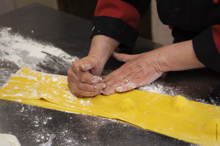 Preparation of fresh pasta, a traditional element of Italian cuisine.