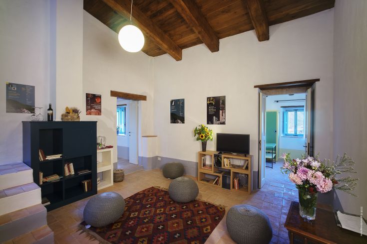 Interior of a renovated historic palace, featuring cozy areas and rustic details.