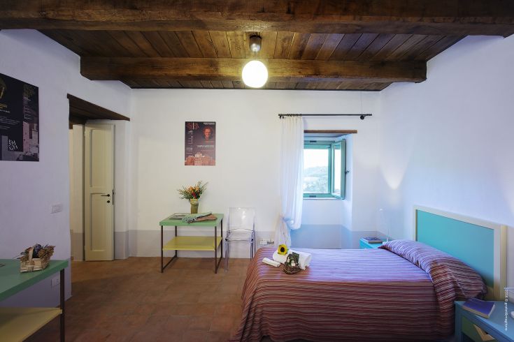 A room in a medieval village palace, featuring decorative details and natural light streaming through the windows.