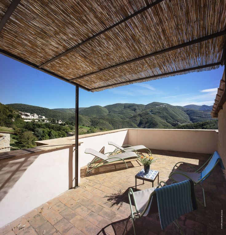 A peaceful terrace overlooking hills, ideal for relaxation and enjoying the landscape.