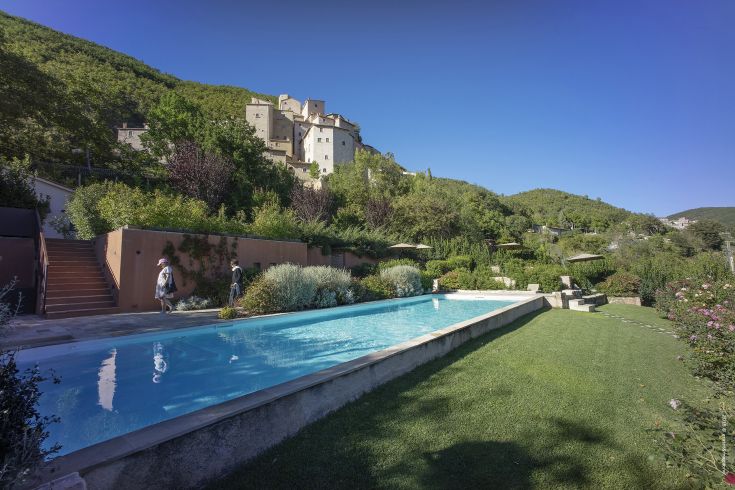 A historic village surrounded by nature in Valnerina, featuring a pool area for relaxation.