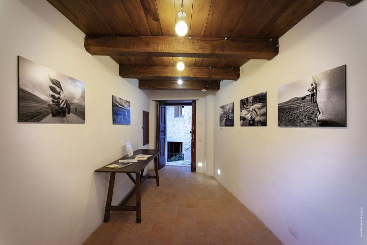 A corridor with photographs displayed on walls in a bright and welcoming environment.