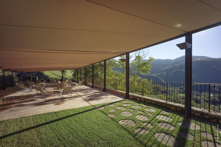 Outdoor space with a view of surrounding green hills, perfect for relaxation and small events.
