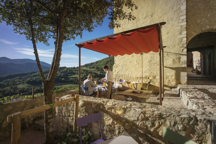 An outdoor lunch in the medieval village of Castello di Postignano, surrounded by history and nature.