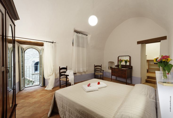 Bright-walled room with designer windows, a welcoming and functional space.