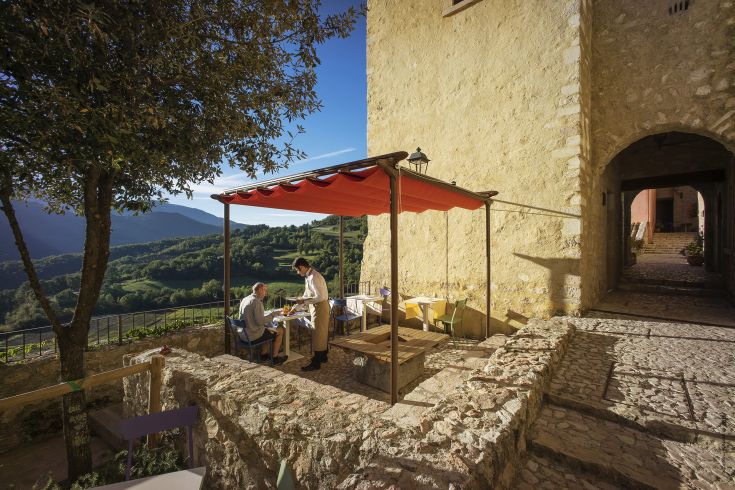 Outdoor restaurant located in a peaceful medieval village, surrounded by nature.