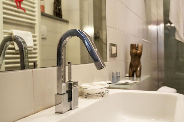 Sleek sink in a contemporary bathroom, featuring a shiny faucet and subtle finishes.