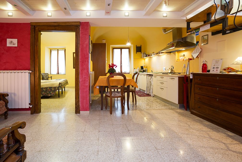 Simple interior of an apartment with an organized kitchen and a well-lit dining area.