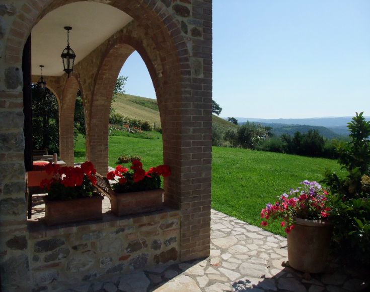 Renovated palace surrounded by natural elements and flowers on the window sills.