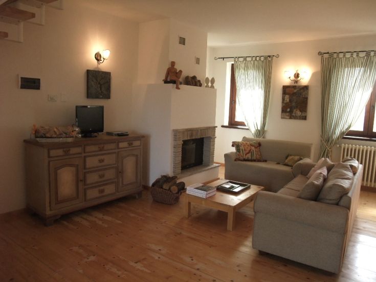 A rustic living room with simple, bright furnishings, perfect for relaxation.