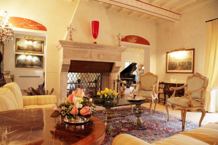 A cozy living room with simple furnishings, a fireplace, and warm atmosphere.