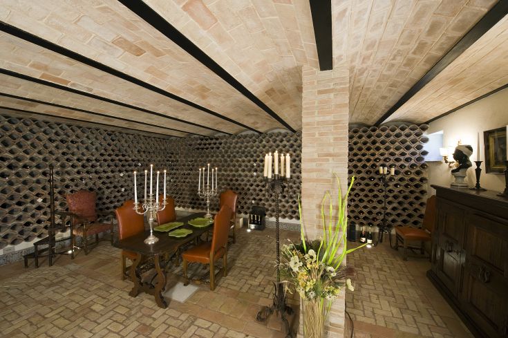 A cozy wine corner with a simple table and some candles, creating a relaxed atmosphere.