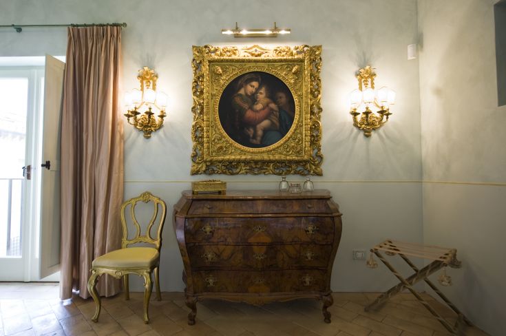 Elegant interiors with wooden furniture and decorative elements, featuring a classic-style painting.