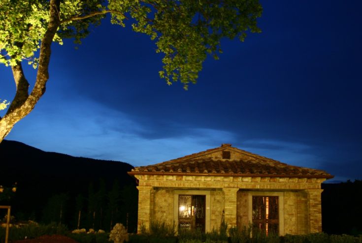 A villa nestled in greenery surrounded by nature at dusk.